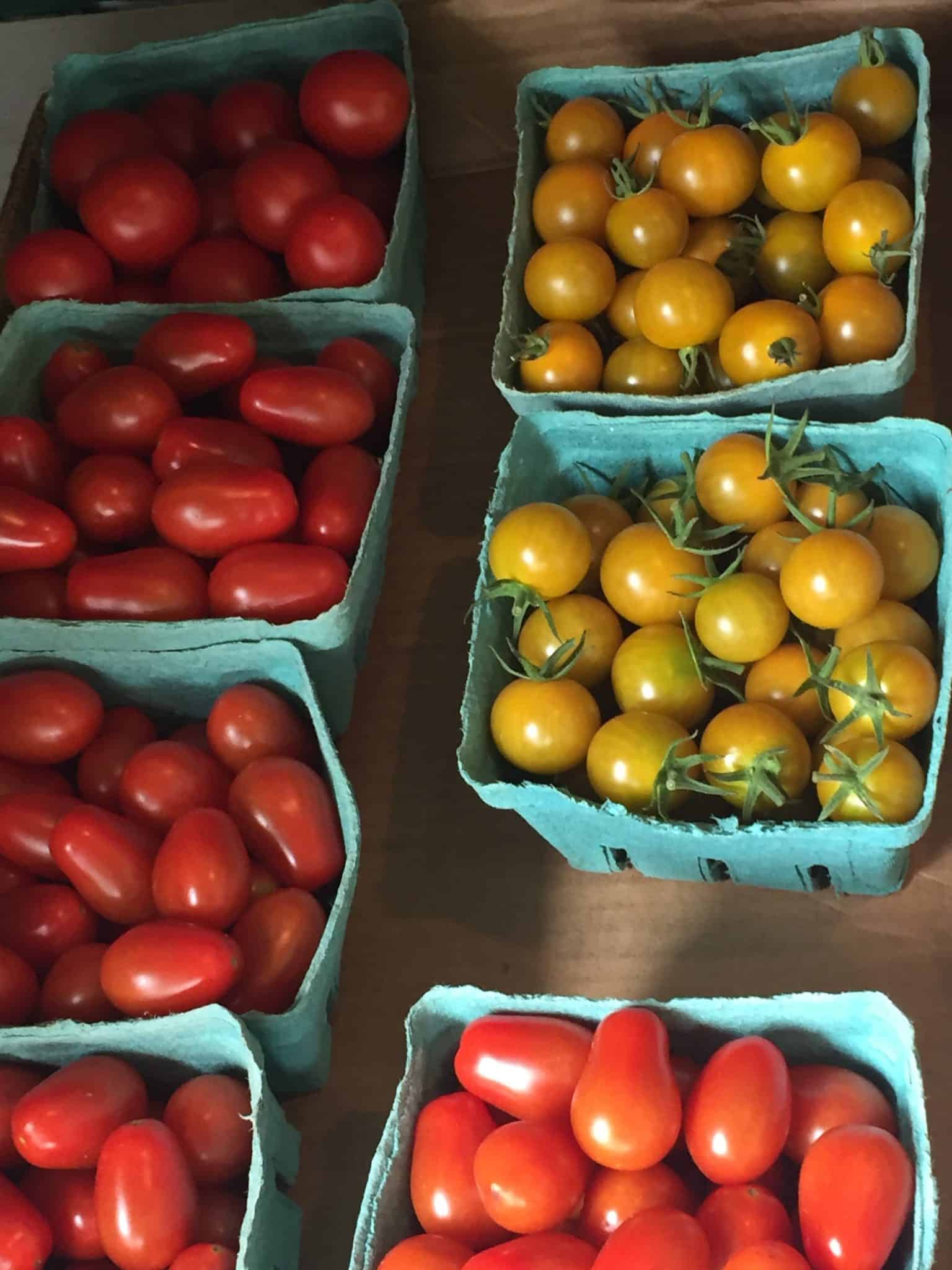 boxes of yellow and red cherry tomatoes