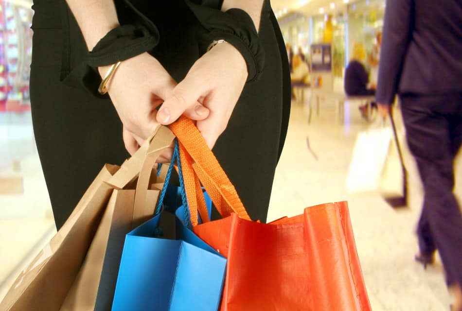 Close up of woman holding multiple shopping bags