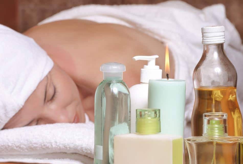 Close up view of woman laying on white table covered in white towel getting a spa treatment